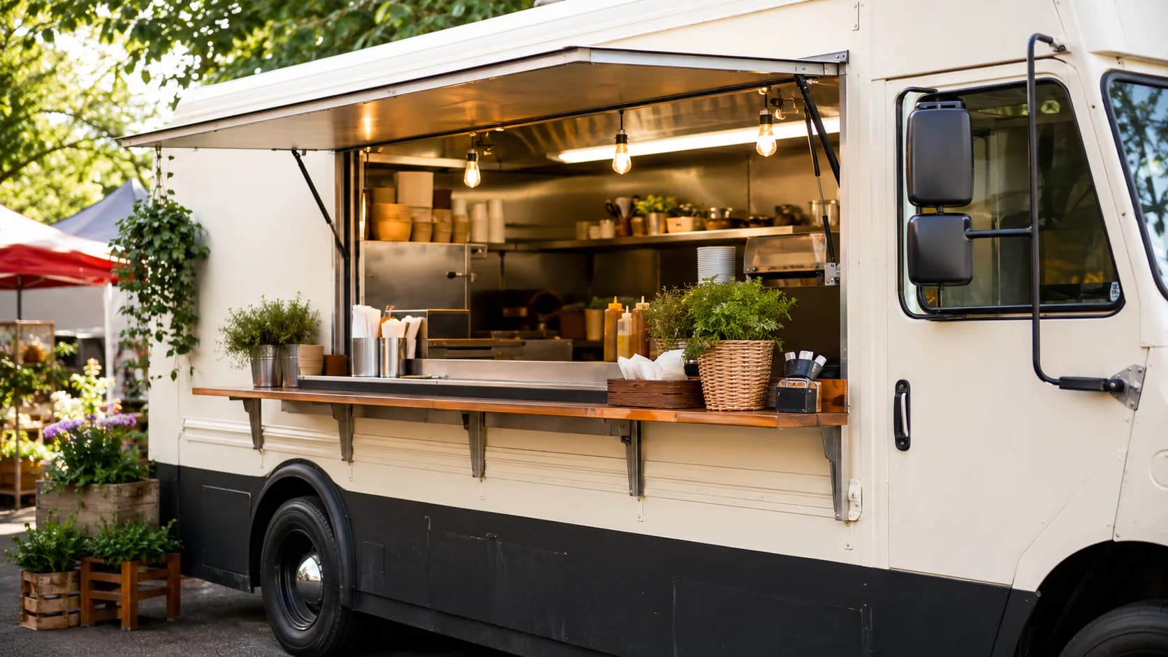 Open service window of a white food truck at an outdoor market.
