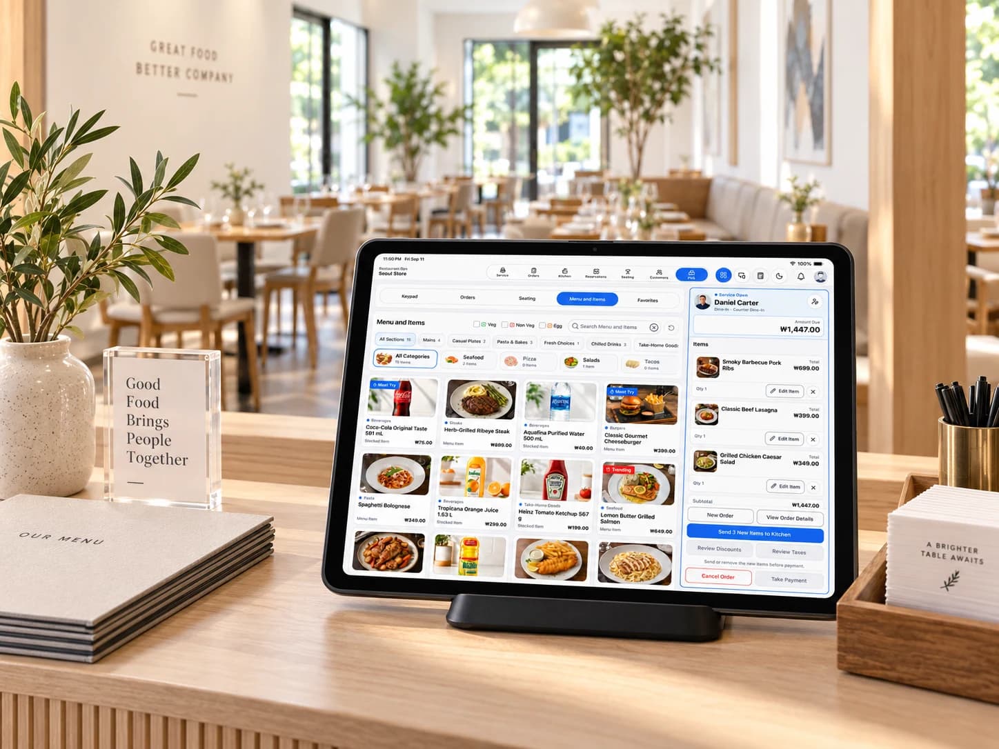 Restaurant POS tablet with menu selection and an active Current Order in a bright restaurant.